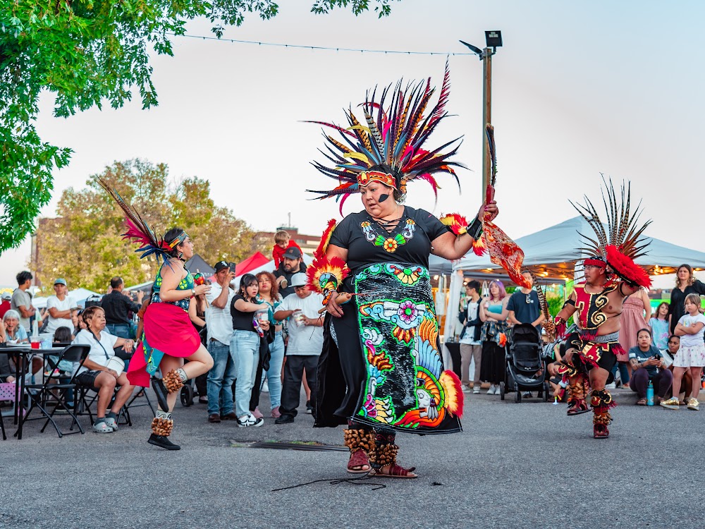 Aztec dancer in feathered headdress performing at a Havana Street market