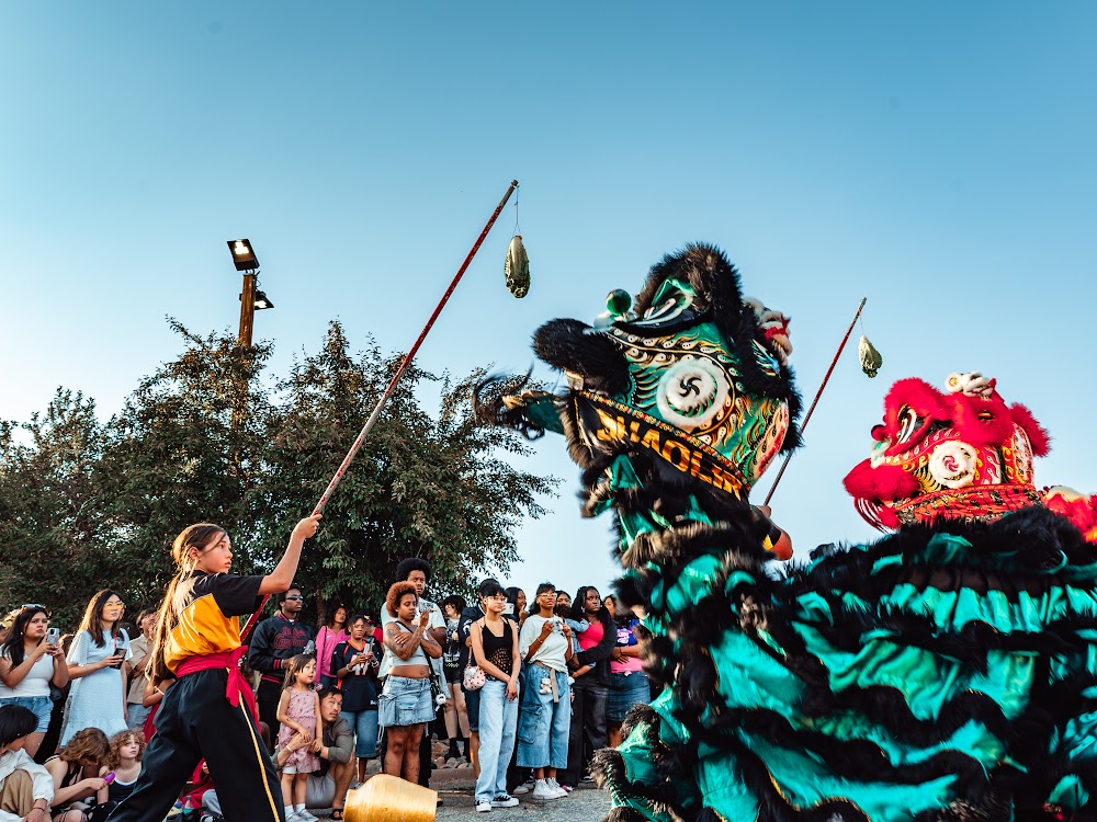 Lion dance performers leaping at Lunar New Year festival