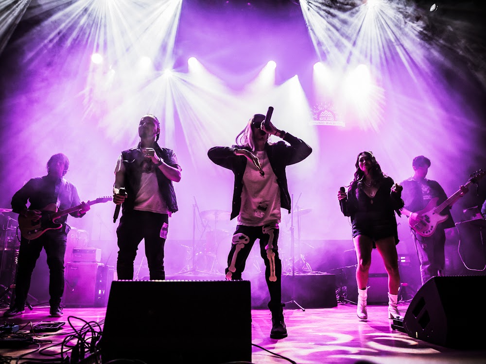 Band performing under purple stage lights at a Bonfire Event Co. event