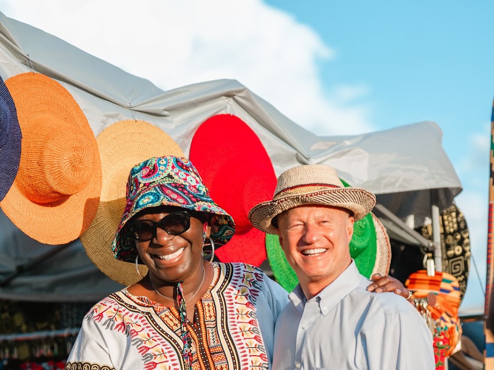 AfriCoast Patterns vendor with Aurora Mayor Mike Coffman at the night market