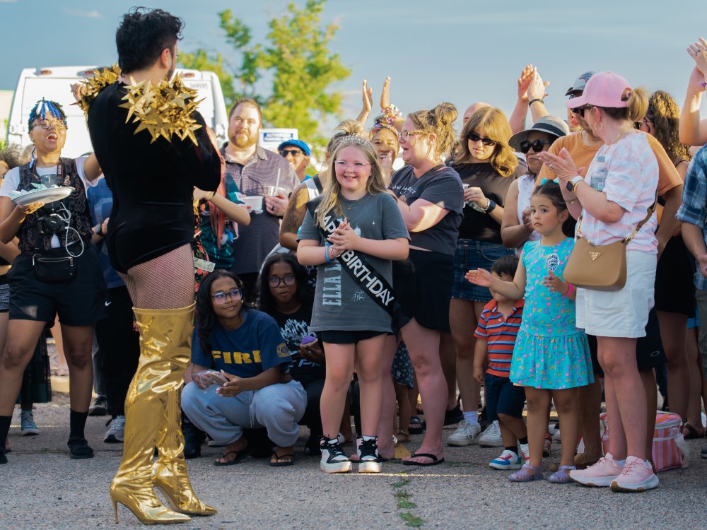 Crowd cheering a performer at Havana Street Night Market in Aurora